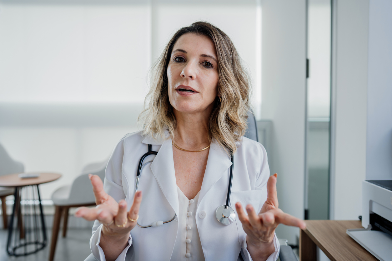 Portrait of a female doctor talking to the camera in online care